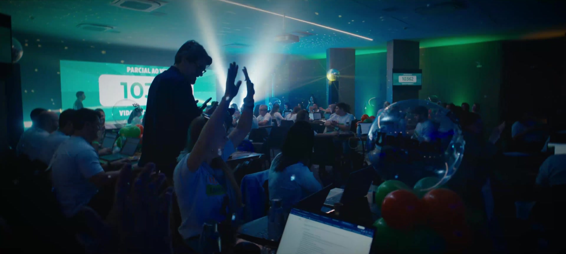 The Unimed team gathered under blue and green event lighting